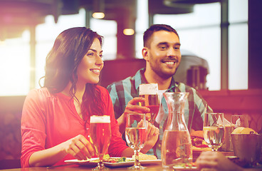 Image showing friends dining and drinking beer at restaurant