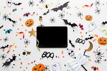 Image showing tablet pc, halloween party decorations and candies