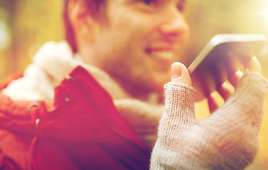 Image showing close up of man recording voice on smartphone