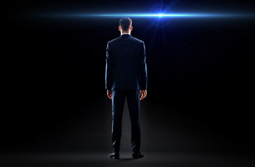 Image showing businessman in suit from back with laser light