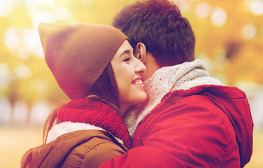 Image showing happy young couple hugging in autumn park