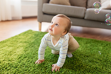 Image showing baby boy playing with soap bubbles at home