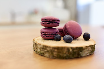 Image showing blueberry macarons on wooden stand