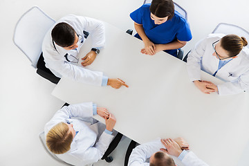 Image showing doctor showing something imaginary on table