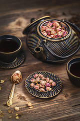 Image showing Cup of hot tea and iron teapot