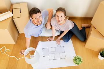 Image showing couple with boxes and blueprint moving to new home