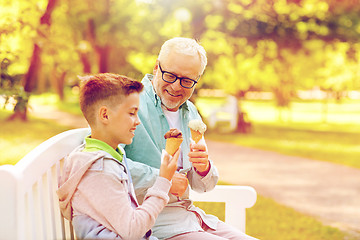 Image showing old man and boy eating ice cream at summer park