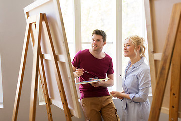 Image showing artists with palette and easel at art school