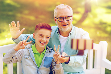 Image showing old man and boy taking selfie by smartphone