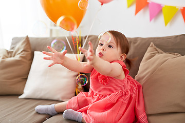 Image showing baby girl with soap bubbles on birthday party