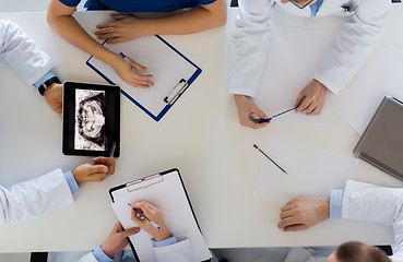 Image showing doctors with jaw x-ray on tablet pc at clinic