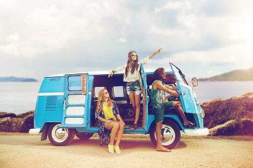 Image showing happy hippie friends in minivan car on island