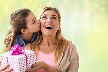 Image showing girl giving birthday present to mother over lights