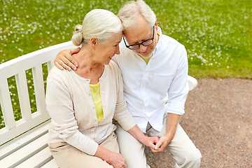 Image showing happy senior couple hugging in city park