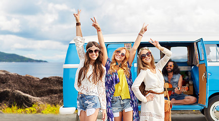 Image showing happy hippie friends at minivan car on island