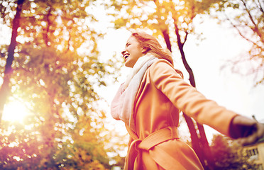 Image showing beautiful happy young woman walking in autumn park