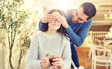 Image showing happy couple drinking tea at cafe