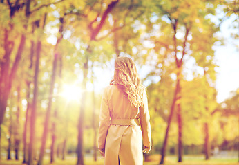 Image showing beautiful young woman walking in autumn park