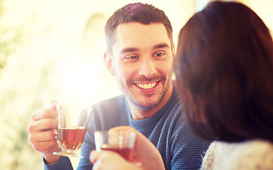 Image showing happy couple drinking tea at cafe