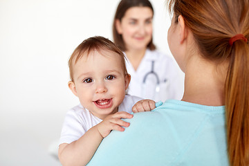 Image showing close up of happy baby with mother and doctor