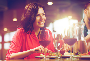 Image showing happy woman having dinner at restaurant