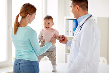 Image showing happy woman with baby and doctor at clinic