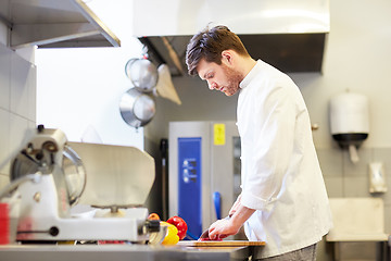 Image showing happy male chef cooking food at restaurant kitchen