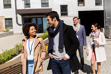 Image showing people with coffee and conference badges in city