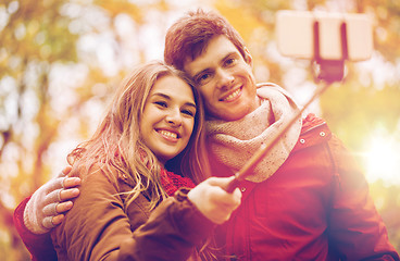 Image showing couple taking selfie by smartphone in autumn park