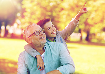 Image showing grandfather and boy pointing finger at summer park