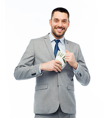 Image showing smiling businessman with american dollar money