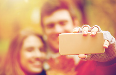 Image showing couple taking selfie by smartphone in autumn park