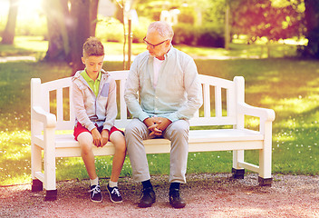 Image showing grandfather and grandson talking at summer park