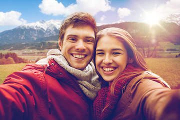Image showing happy couple taking selfie over alps mountains
