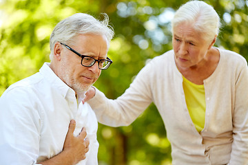 Image showing senior man feeling sick at summer park