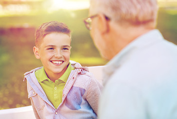 Image showing grandfather and grandson talking at summer park
