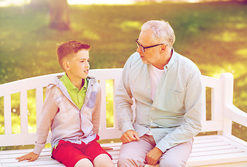 Image showing grandfather and grandson talking at summer park