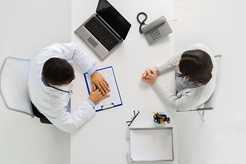 Image showing doctor with cardiogram and patient at hospital