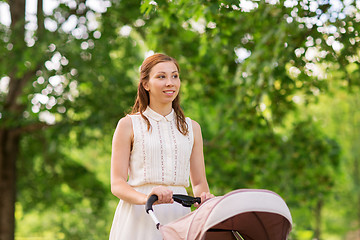 Image showing happy mother with child in stroller at summer park