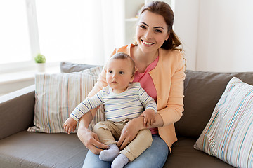 Image showing happy young mother with little baby at home