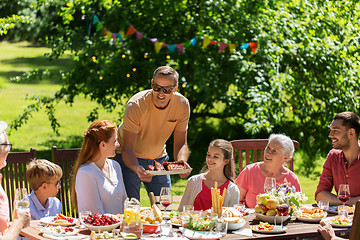 Image showing happy family having dinner or summer garden party