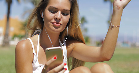 Image showing Charming girl with phone and headphones