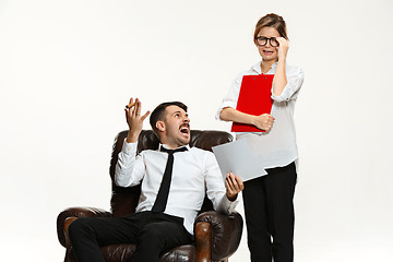 Image showing The young man and beautiful woman in business suit at office on white background