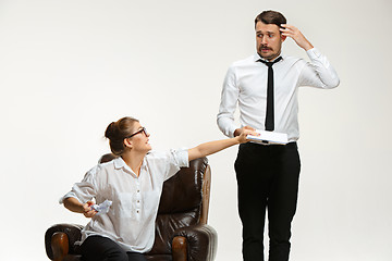 Image showing The young man and beautiful woman in business suit at office on white background