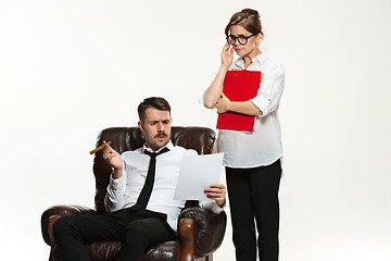 Image showing The young man and beautiful woman in business suit at office on white background