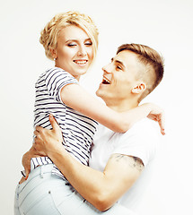 Image showing young pretty teenage couple, hipster guy with his girlfriend happy smiling and hugging isolated on white background, lifestyle people concept 