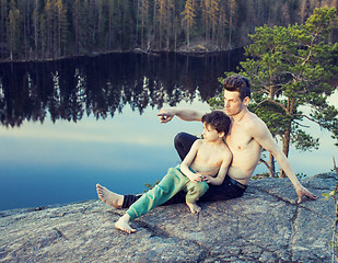 Image showing middle age man with little cute son doing sport yoga on the top of the mountain together, happy family lifestyle people outdoor, summer wild nature for training 