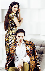 Image showing pretty stylish woman in fashion dress with leopard print together in luxury rich room interior, lifestyle people concept, modern brunette together 