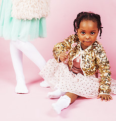 Image showing lifestyle people concept: diverse nation children playing together, caucasian boy with african little girl holding candy happy smiling 