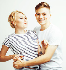 Image showing young pretty teenage couple, hipster guy with his girlfriend happy smiling and hugging isolated on white background, lifestyle people concept 